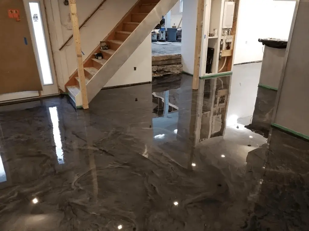 Floor coating installer diamond grinding a concrete garage floor in Miami before applying an epoxy and polyaspartic system